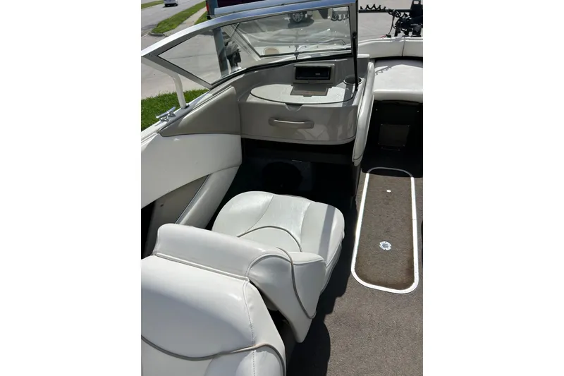 Slide: The Image of Interior of a 1999 Bayliner 1954 Capri boat with white seating and carpeted floor. - 20