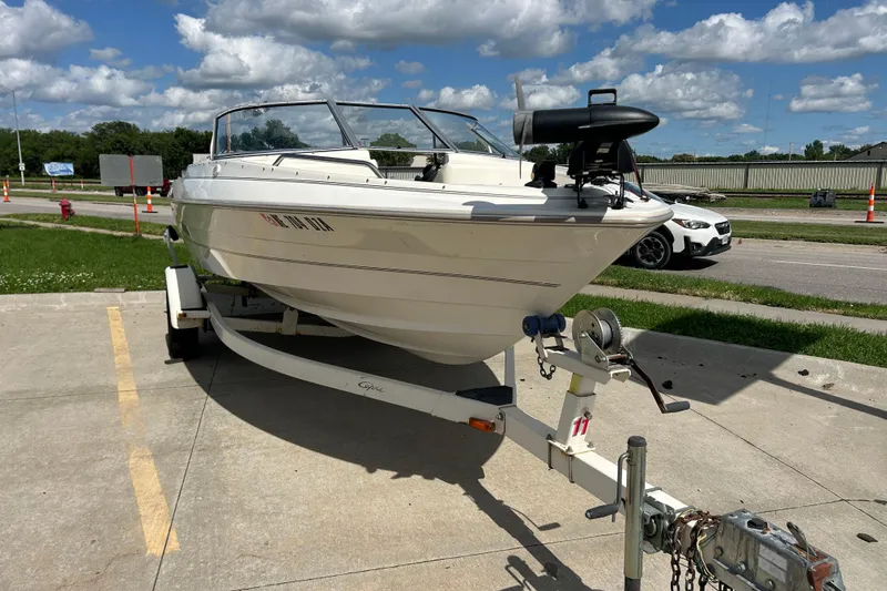Slide: The Image of 1999 Bayliner 1954 Capri boat on trailer under a partly cloudy sky. - 5