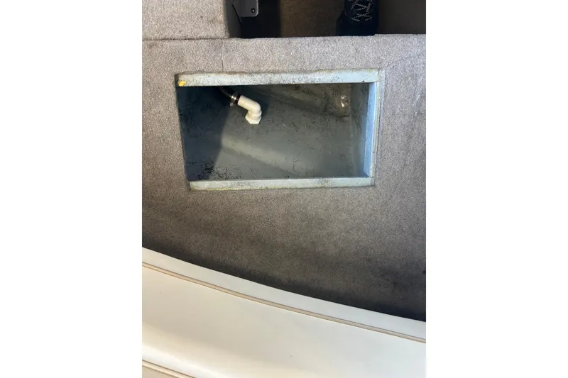 Slide: The Image of Interior view of a 1999 Bayliner 1954 Capri boat showing a storage compartment. - 27