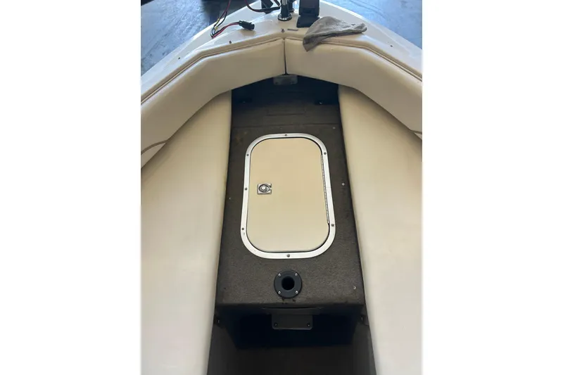 Slide: The Image of Interior of a 1999 Bayliner 1954 Capri boat, featuring a storage compartment. - 19