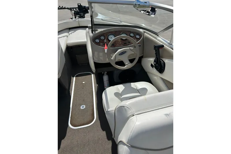Slide: The Image of 1999 Bayliner 1954 Capri boat interior with steering wheel and dashboard controls. - 21
