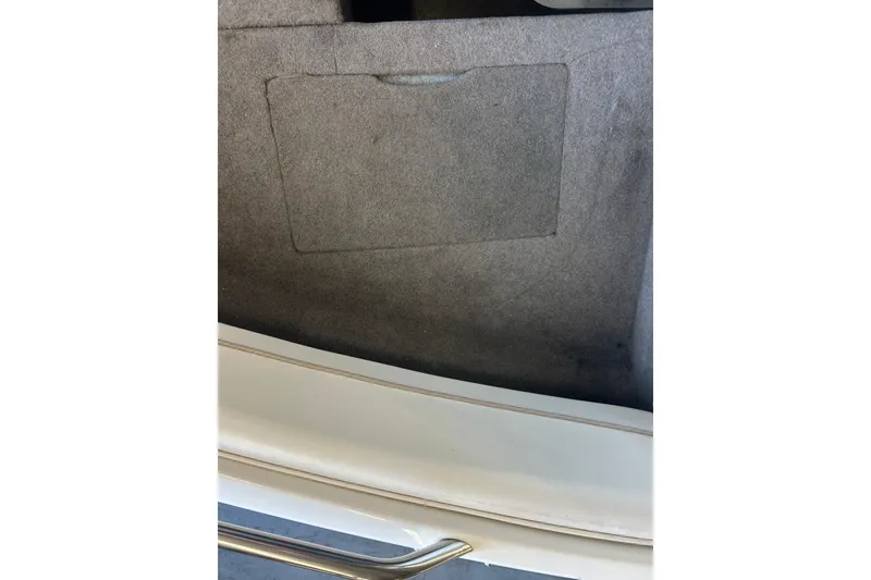 Slide: The Image of Interior view of a 1999 Bayliner 1954 Capri boat with carpeted surface. - 25