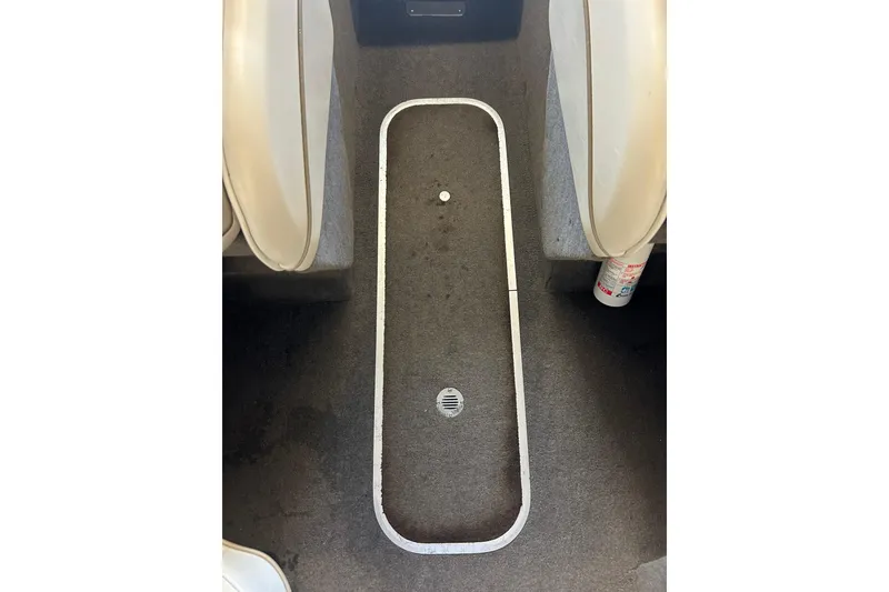 Slide: The Image of Interior of a 1999 Bayliner 1954 Capri boat, featuring carpeted flooring and seating. - 24