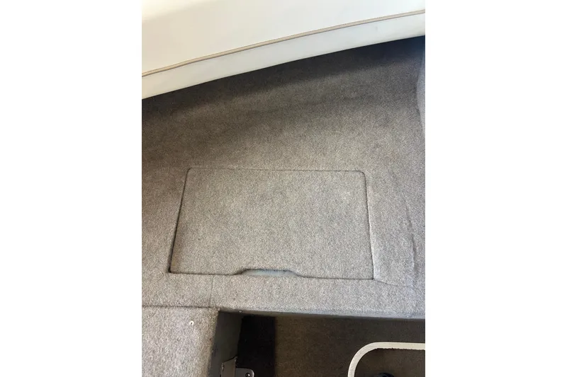 Slide: The Image of Interior view of a 1999 Bayliner 1954 Capri boat with carpeted flooring. - 28