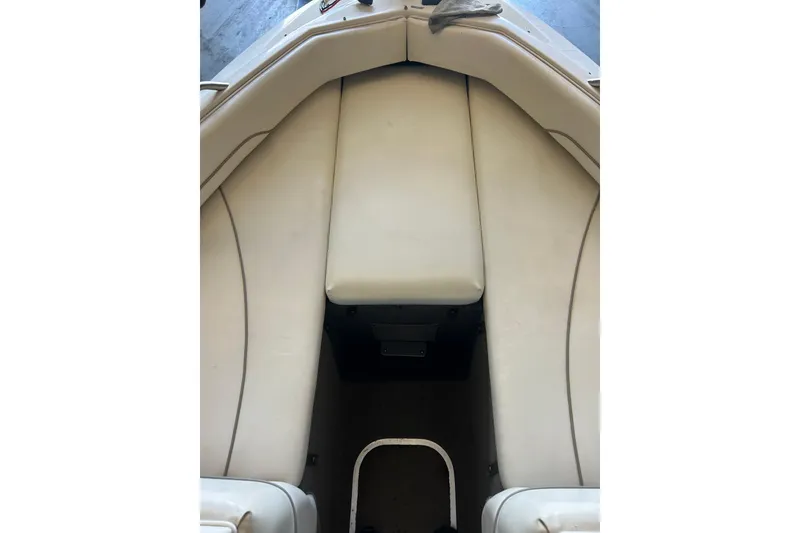 Slide: The Image of Interior view of 1999 Bayliner 1954 Capri boat with beige seating. - 17