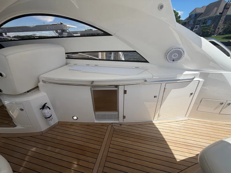 Slide: The Image of The image shows the deck of a 2008 Sunseeker Portofino 53 with sleek wooden flooring. - 10