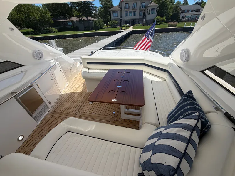 Slide: The Image of The image shows the cockpit of a Sunseeker Portofino 53 with elegant seating and a wooden table. - 12