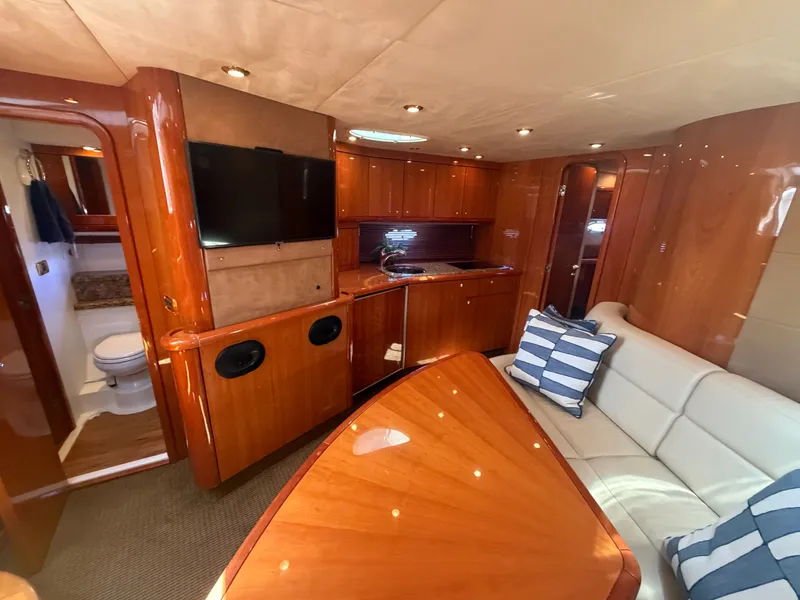 Slide: The Image of Interior of a Sunseeker Portofino 53 with elegant wood furnishings and comfortable seating. - 14
