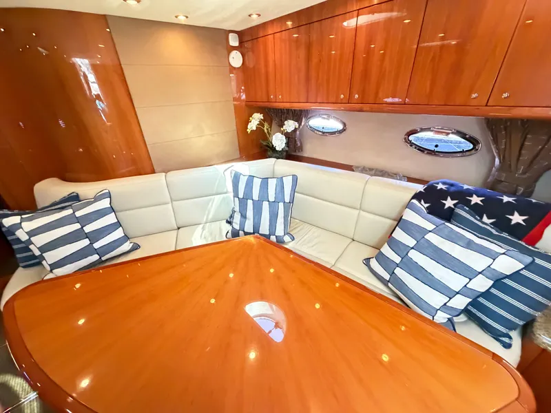 Slide: The Image of Interior of a 2008 Sunseeker Portofino 53 with elegant seating area and wooden table. - 16