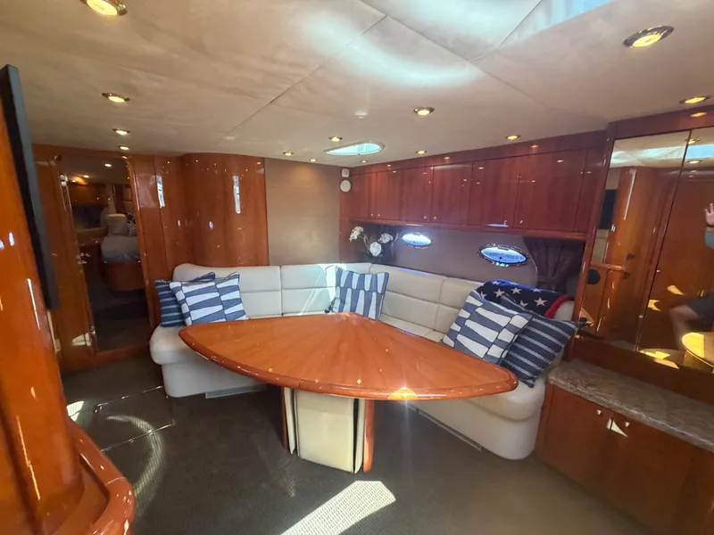 Slide: The Image of Interior of Sunseeker Portofino 53 with elegant seating area and wooden table. - 18