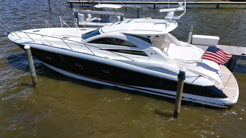 Slide: The Image of 2008 Sunseeker Portofino 53 docked with an American flag displayed. - 2