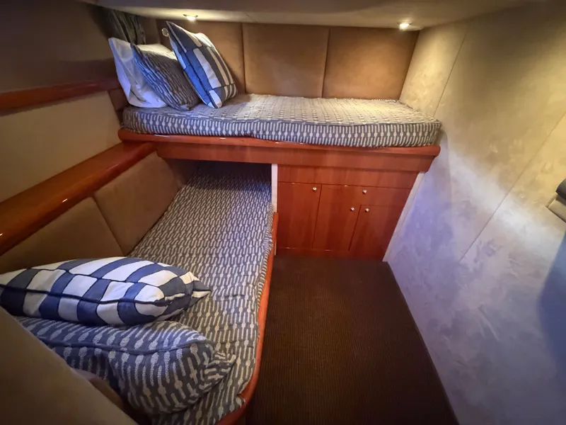 Slide: The Image of Interior of the Sunseeker Portofino 53 with two bunk beds and cozy lighting. - 21