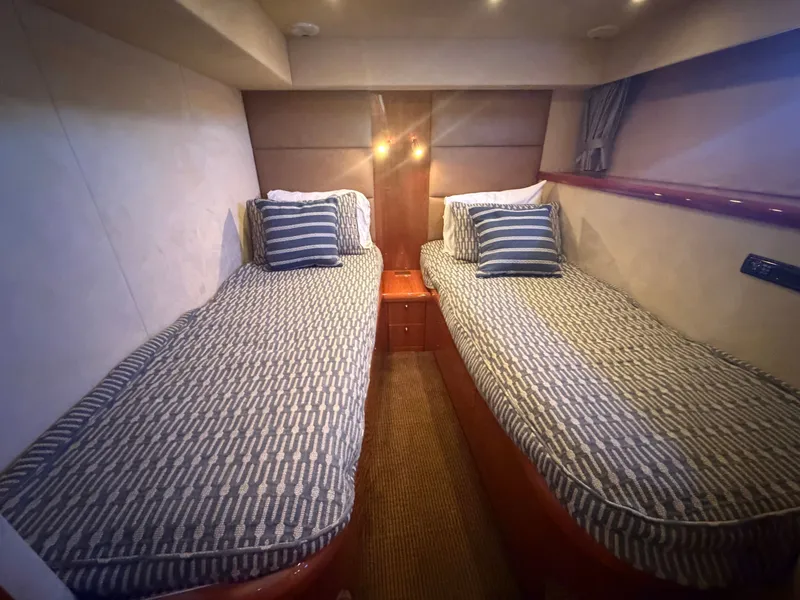 Slide: The Image of Two single beds in a cozy cabin with striped bedding and wooden furnishings. - 22