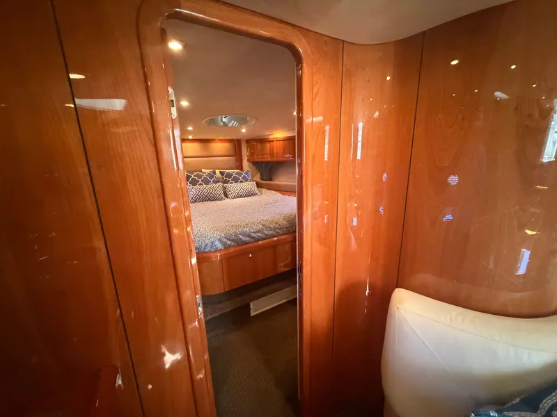 Slide: The Image of Interior of a 2008 Sunseeker Portofino 53 featuring a cozy bedroom and wooden walls. - 24
