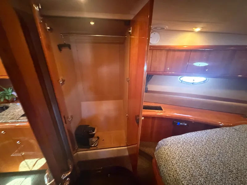 Slide: The Image of Interior of a 2008 Sunseeker Portofino 53 with wooden furnishings and a bed. - 26