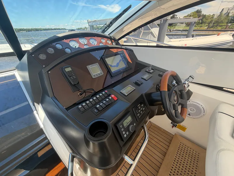 Slide: The Image of The cockpit of a 2008 Sunseeker Portofino 53 with modern navigation instruments. - 6