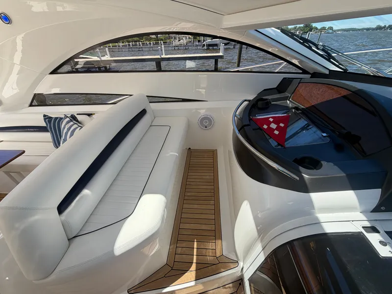 Slide: The Image of Interior of a Sunseeker Portofino 53 with white seating and wooden flooring. - 9