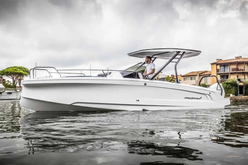 The Image of A modern motorboat with a sleek white hull and protective canopy on calm water. - 0