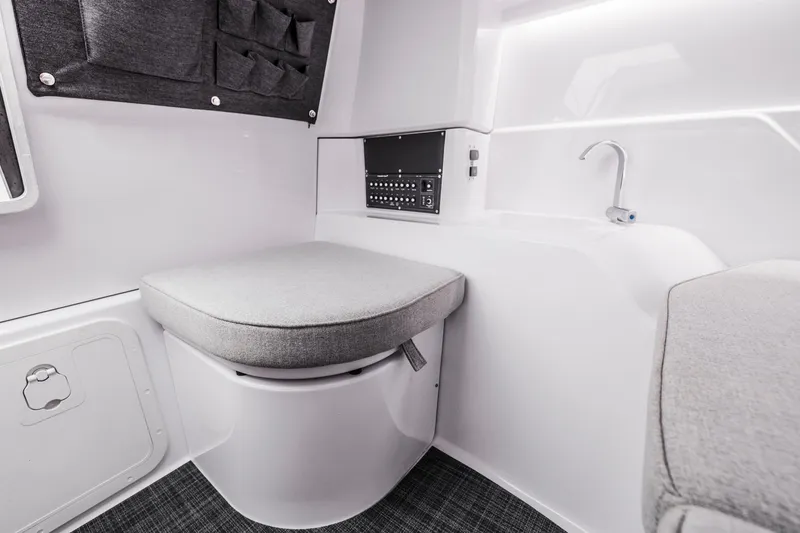 Slide: The Image of Interior of the 2023 Axopar 25 Cross Top with gray upholstery and a sink. - 15