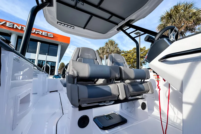 Slide: The Image of 2023 Axopar 25 Cross Top boat interior with modern seating and steering wheel. - 17