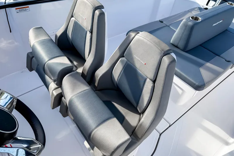 Slide: The Image of 2023 Axopar 25 Cross Top boat interior with sleek, modern seating design. - 8