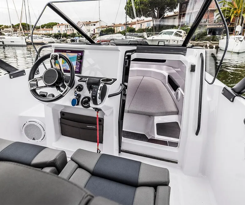 Slide: The Image of Interior view of an Axopar 25 Cross Top boat with helm and cabin. - 6