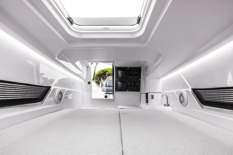 Slide: The Image of Interior of a 2023 Axopar 25 Cross Top with modern design and white surfaces. - 7