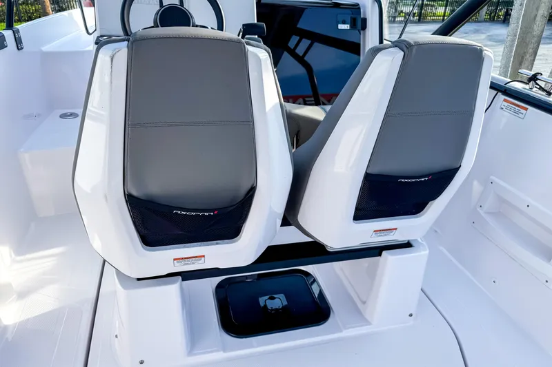 Slide: The Image of 2023 Axopar 25 Cross Top boat interior with dual seats and modern design. - 7