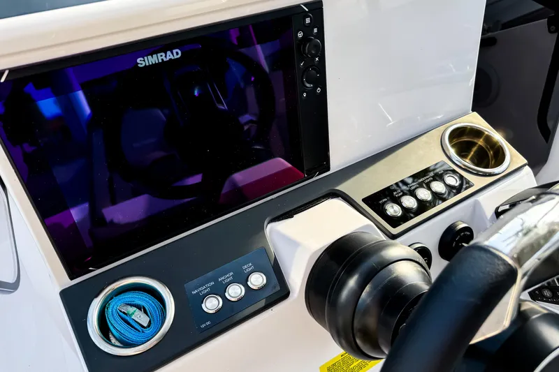 Slide: The Image of Control panel of 2023 Axopar 25 Cross Top boat with Simrad display and switches. - 11