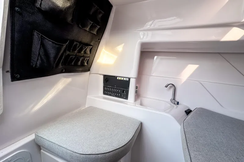 Slide: The Image of Interior of 2023 Axopar 25 Cross Top boat with seating and compact sink. - 14