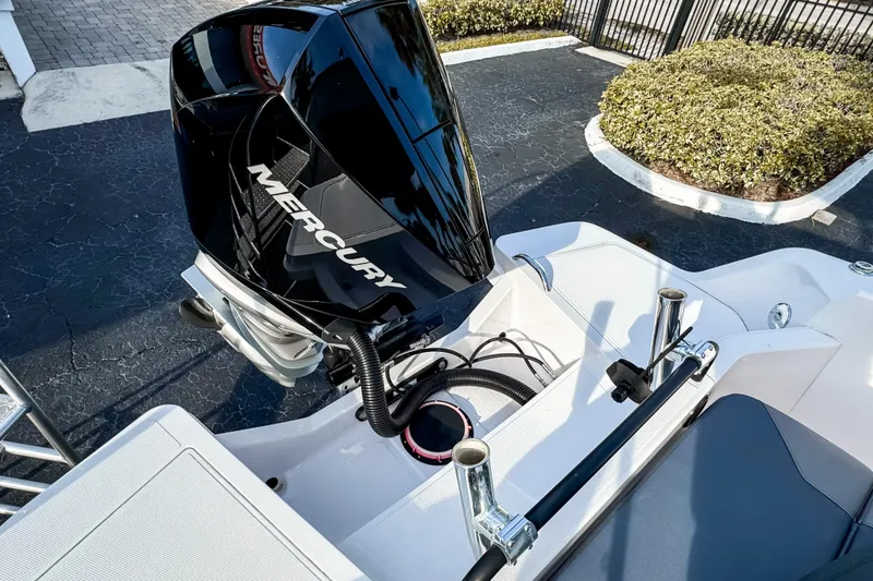Slide: The Image of 2023 Axopar 25 Cross Top boat with Mercury outboard engine, docked on pavement. - 18