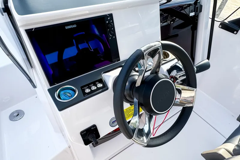 Slide: The Image of Steering console of 2023 Axopar 25 Cross Top boat with Simrad display. - 10
