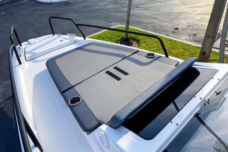 Slide: The Image of 2023 Axopar 25 Cross Top boat deck with cushioned seating and cup holders. - 13