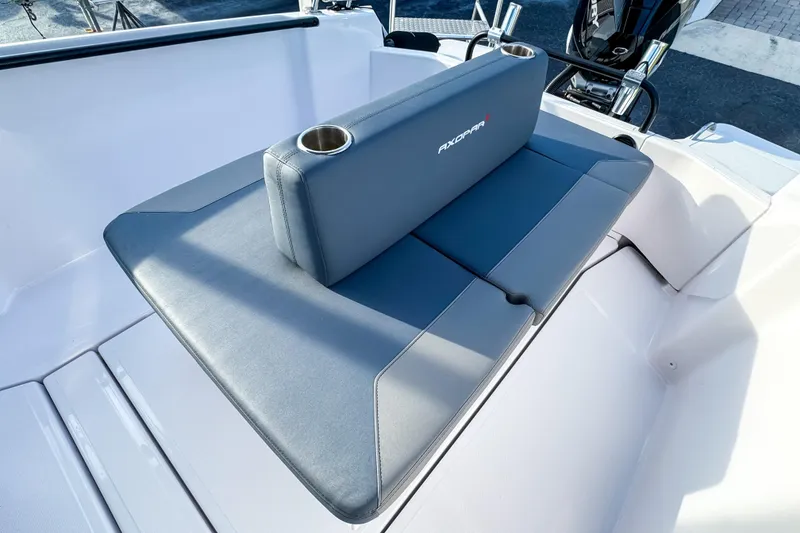 Slide: The Image of 2023 Axopar 25 Cross Top boat seating with integrated cup holders. - 6