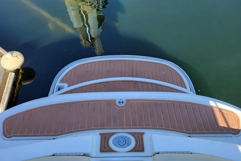 Slide: The Image of Rear view of a 2005 Cobalt 255 boat swim platform, docked on calm water. - 6