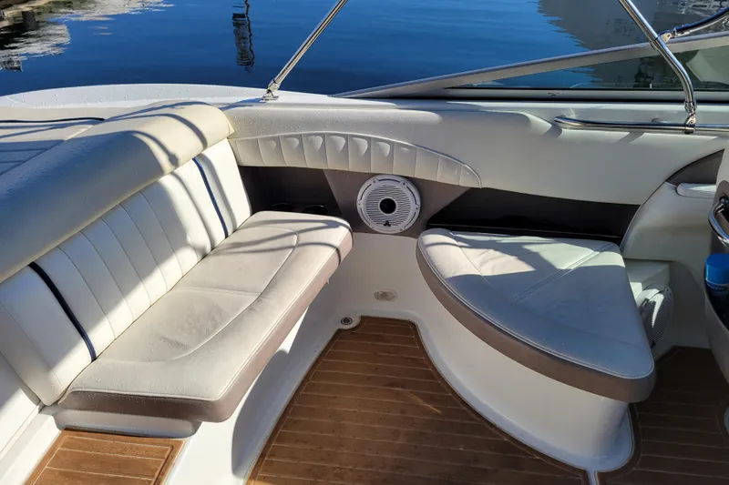 Slide: The Image of Interior of a 2005 Cobalt 255 boat with cushioned seating and wooden flooring. - 7