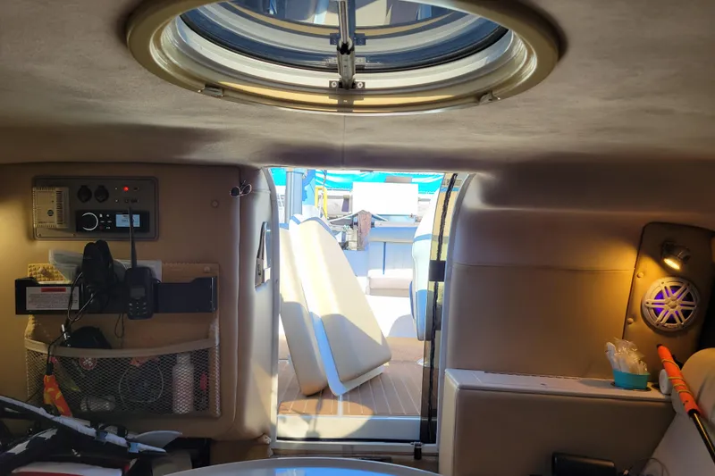 Slide: The Image of Interior of a 2005 Cobalt 255 boat cabin with control panel and seating area. - 16