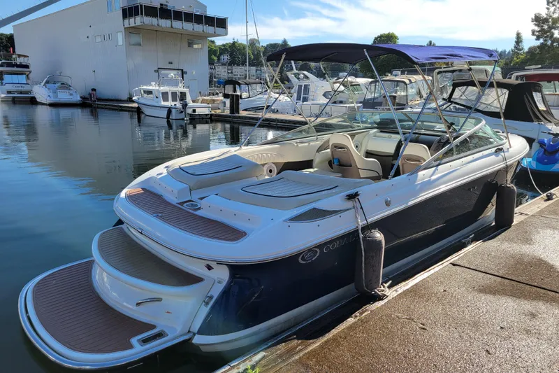 Slide: The Image of 2005 Cobalt 255 boat docked at marina, featuring sleek design and spacious seating. - 3
