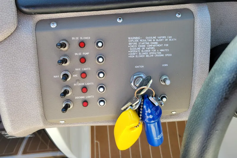 Slide: The Image of Control panel of a 2005 Cobalt 255 boat with ignition keys and switches. - 12