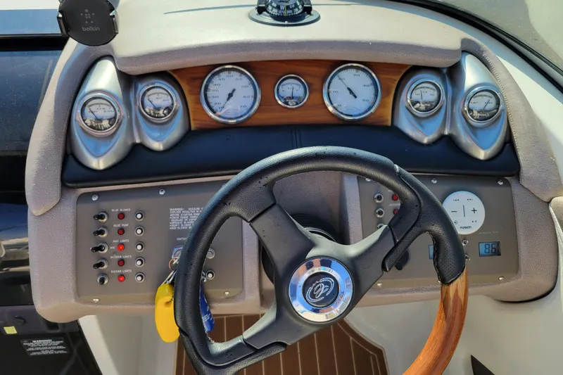 Slide: The Image of Dashboard of a 2005 Cobalt 255 boat with steering wheel and gauges. - 11
