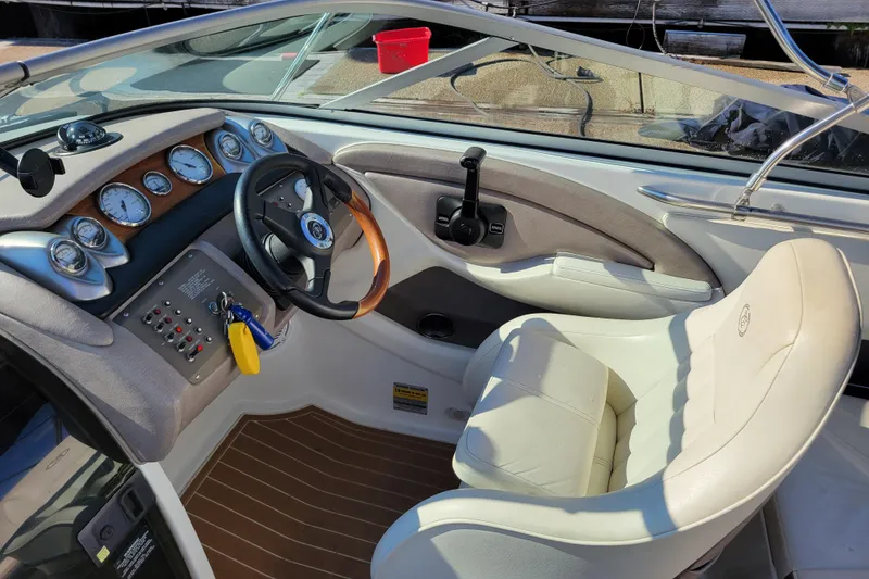 Slide: The Image of Interior of a 2005 Cobalt 255 boat with steering wheel and gauges. - 10