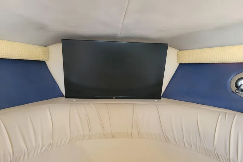 Slide: The Image of Interior of a 2005 Cobalt 255 boat with a mounted flat-screen TV. - 15