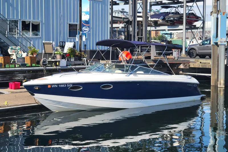 The Image of 2005 Cobalt 255 boat docked at marina with blue and white exterior. - 0