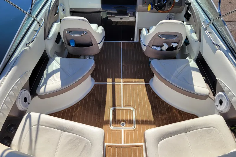 Slide: The Image of Interior of a 2005 Cobalt 255 boat with white seating and wood flooring. - 5