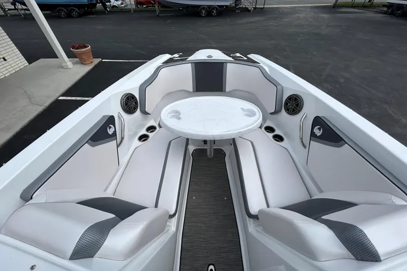 Slide: The Image of 2023 Scarab 255 Wake ID boat interior with seating and table setup. - 13