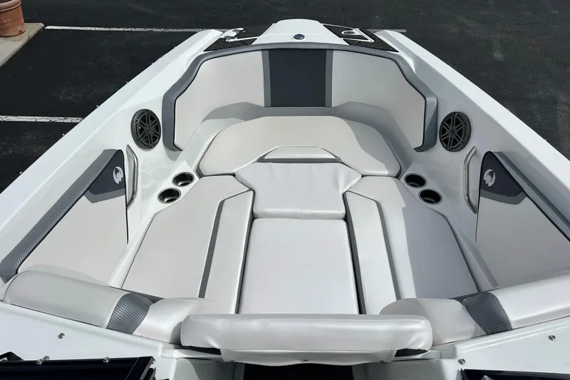 Slide: The Image of 2023 Scarab 255 Wake ID boat interior with white and gray seating, cup holders, and speakers. - 15