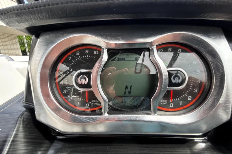 Slide: The Image of Dashboard of 2023 Scarab 255 Wake ID boat showing RPM gauges and digital display. - 17