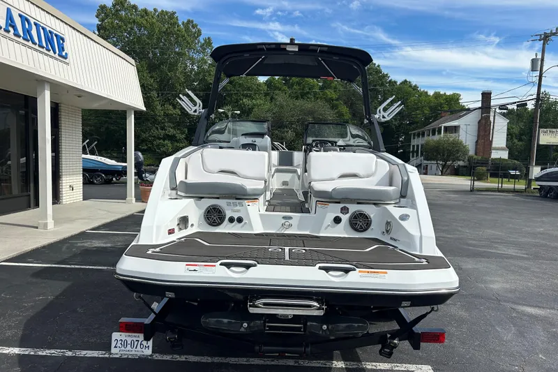 Slide: The Image of 2023 Scarab 255 Wake ID boat displayed in a parking lot near a marine store. - 25
