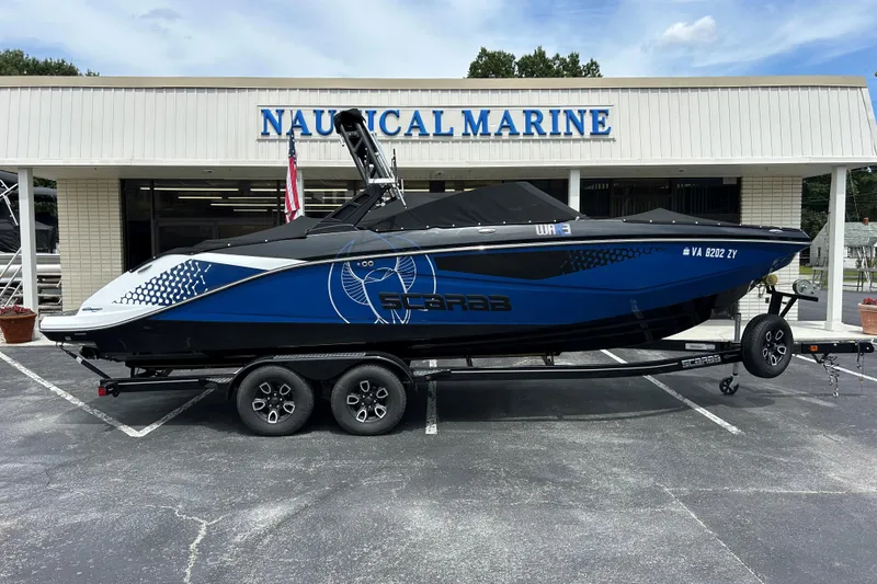 Slide: The Image of 2023 Scarab 255 Wake ID boat on trailer at Nautical Marine dealership. - 26