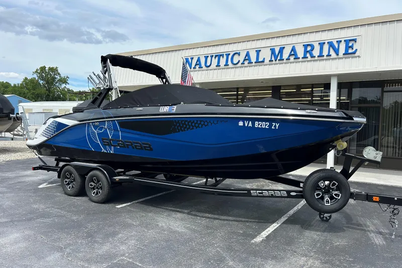 Slide: The Image of 2023 Scarab 255 Wake ID boat on trailer outside Nautical Marine dealership. - 27